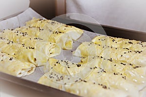 Turkish baked cakes with white sesame and black cumin on baking paper