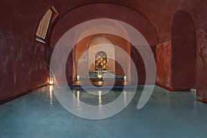 Turkish baths with vaporous blue salt water, oil lamps photo