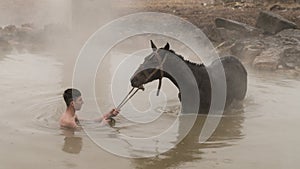 Turkish boy and his horse in thermal water, Guroymak, Bitlis
