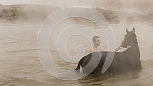 Turkish boy and his horse in thermal water, Guroymak, Bitlis