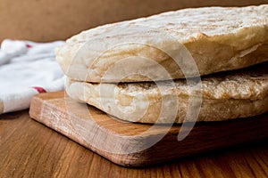 Turkish Bread Bazlama on wooden surface.