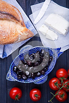 Turkish breakfast with black olives, bread, panir cheese and cherry tomatoes photo