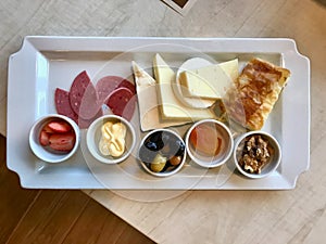 Turkish Breakfast Plate with Cheese, Various Jams, Salami, Borek and Dried Fruits.