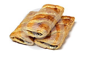 Turkish buns of bread stuffed with feta cheese and spinach on white background close up