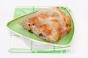 Turkish burek with meat on a green plate