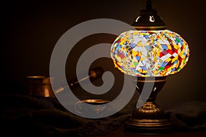 Turkish cafe illuminated by Turkish lamp on wooden table photo