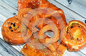 Turkish Churros Halka Tatlisi circular dessert, Apple pie, Cinnamon swirl puff roll sweetened with honey and raisins and filled