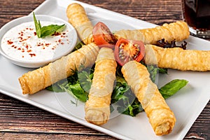 Turkish Cigar Shaped Rolls on a white porcelain plate. The Turkish name is Sigara Boregi