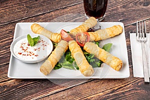 Turkish Cigar Shaped Rolls on a white porcelain plate. The Turkish name is Sigara Boregi