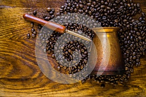 Turkish coffee concept. Copper coffee pot Cezve, vintage coffee grinder, cup, coffee beans on a dark wooden background. Top view