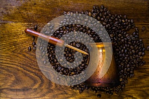 Turkish coffee concept. Copper coffee pot Cezve, vintage coffee grinder, cup, coffee beans on a dark wooden background. Top view