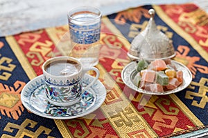 Turkish coffee with glass of water and turkish delights