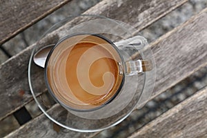 Turkish coffee with milk in glass cup close up