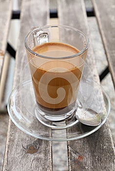 Turkish coffee with milk in glass cup close up