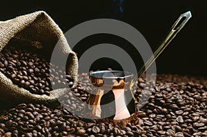 A Turkish coffee pot with beans