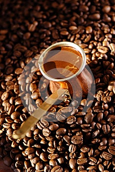 Turkish coffee pot with coffee beans