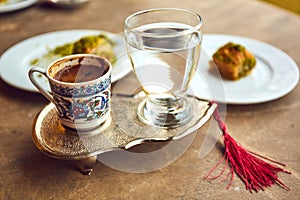 Turkish coffee and turkish delight with traditional embossed metal tray and cup