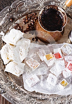 Turkish coffee and Turkish sweets over dark wooden background