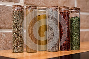 Turkish colored spices in glass containers tubes with corks, oriental cuisine