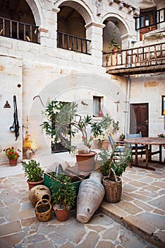 Turkish courtyard with green plants and old pitchers