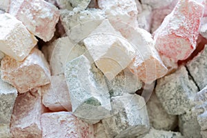 Turkish delight colorful pieces in powdered sugar. Rahat lokum traditional Turkish sweets, Turkey. Close up image