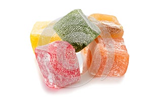 Turkish delight. Different types of rahat locum, five colorful pieces of sweet oriental delights in powered sugar. Close-up view