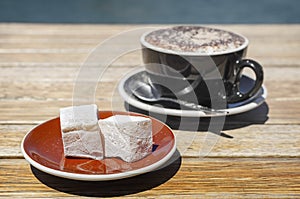 Turkish delight (lokum) confection with black tasting coffee.