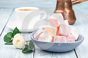 Turkish delight or lokum confection rose and lemon flavored with cup of coffee and cezve, horizontal