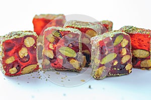 Turkish delight - lokum or rahat lokum with pistachios on grey background. Traditional eastern cuisine. Traditional