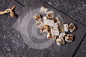 Turkish delight with nuts on dark stone background