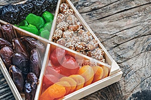 Turkish delight oriental sweets dried fruits and nuts in a wooden box. Background. Healthy vegan food. Natural food. Selective