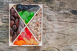 Turkish delight oriental sweets dried fruits and nuts in a wooden box. Background. Healthy vegan food. Natural food. Selective