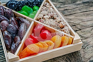 Turkish delight oriental sweets dried fruits and nuts in a wooden box. Background. Healthy vegan food. Natural food. Selective