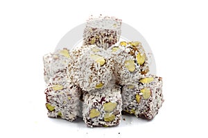 Turkish Delight with Pistachio isolated on a white background. Turkish Delight with Coconut Grain on it and Pistachio inside