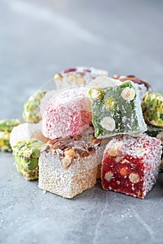 Turkish delight with pistachios on grey background. Copy space. Traditional eastern cuisine. Traditional middle eastern