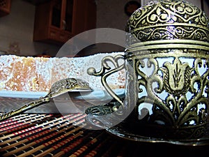 Turkish delight from rose petals and Fildjan - turkish coffee cup and saucer. Oriental sweets. Natural and healthy food.