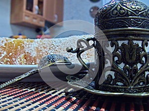 Turkish delight from rose petals and Fildjan - turkish coffee cup and saucer. Oriental sweets. Natural and healthy food.