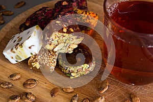 Turkish delight with tea on a wooden background