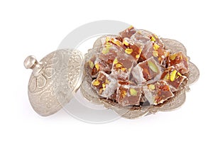 Turkish delights with pistachio nut in a metal sugar bowl photo