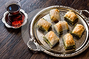 Turkish Dessert Baklava with tea on silver tray.