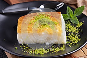 Turkish dessert kazandibi. Caramelized milk pudding with cinnamon photo