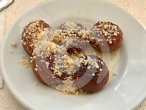 Turkish Dessert Kemalpasa with Hazelnut Powder and Sherbet / Serbet.