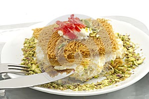 Turkish dessert kunefe, kunafa, kadayif with pistachio powder and cheese