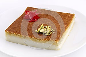 Turkish dessert kunefe, kunafa, kadayif with pistachio powder and cheese photo