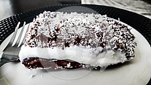 Turkish Dessert Saray Sarma / Chocolate pudding with cream and coconut powder photo