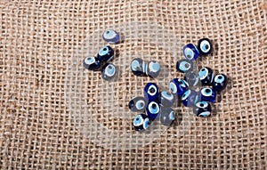 Turkish evil eye beads on canvas texture