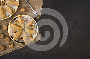 Turkish famous traditional homemade flour halva served with walnut in plate on rustic background photo