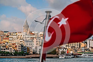 Turkish flag on a flashstock against the background of Istanbul`s neighborhoods of the Bosphorus Strait and Galata tower photo
