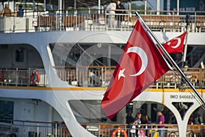 Turkish flag in the foreground and istanbul ferry