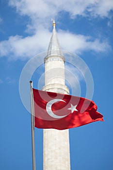 Turkish flag in front of minaret